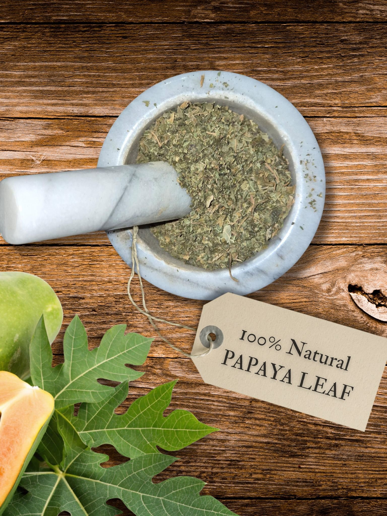 Papaya leaf dried in a mortar and pestle with Carica papaya plant background - The Herb Peddler