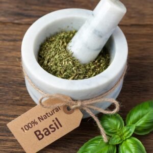 Basil dried herb in a mortar and pestle with Ocimum basilicum plant background - The Herb Peddler