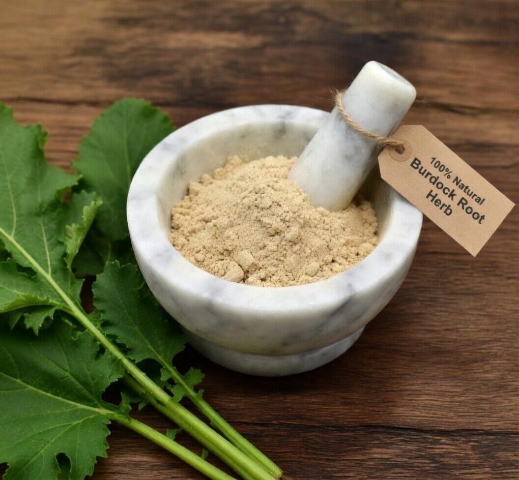 Burdock root powder, organic, in a mortar and pestle with Arctium lappa plant background - The Herb Peddler