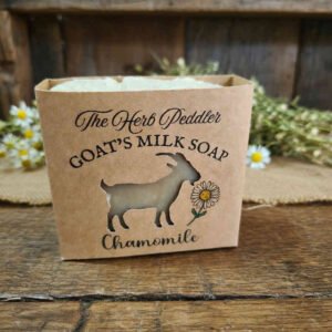 Rustic hot-process Chamomile Goat's Milk Soap bar with real chamomile flowers on top, displayed with dried chamomile blossoms - The Herb Peddler