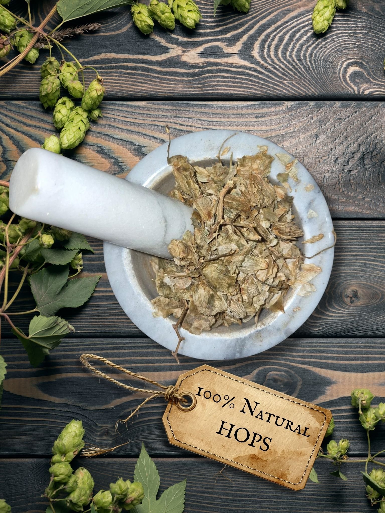 Hops strobiles in a mortar and pestle with Humulus lupulus plant background - The Herb Peddler