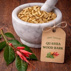Quassia wood chips in a mortar and pestle with Quassia amara plant background - The Herb Peddler