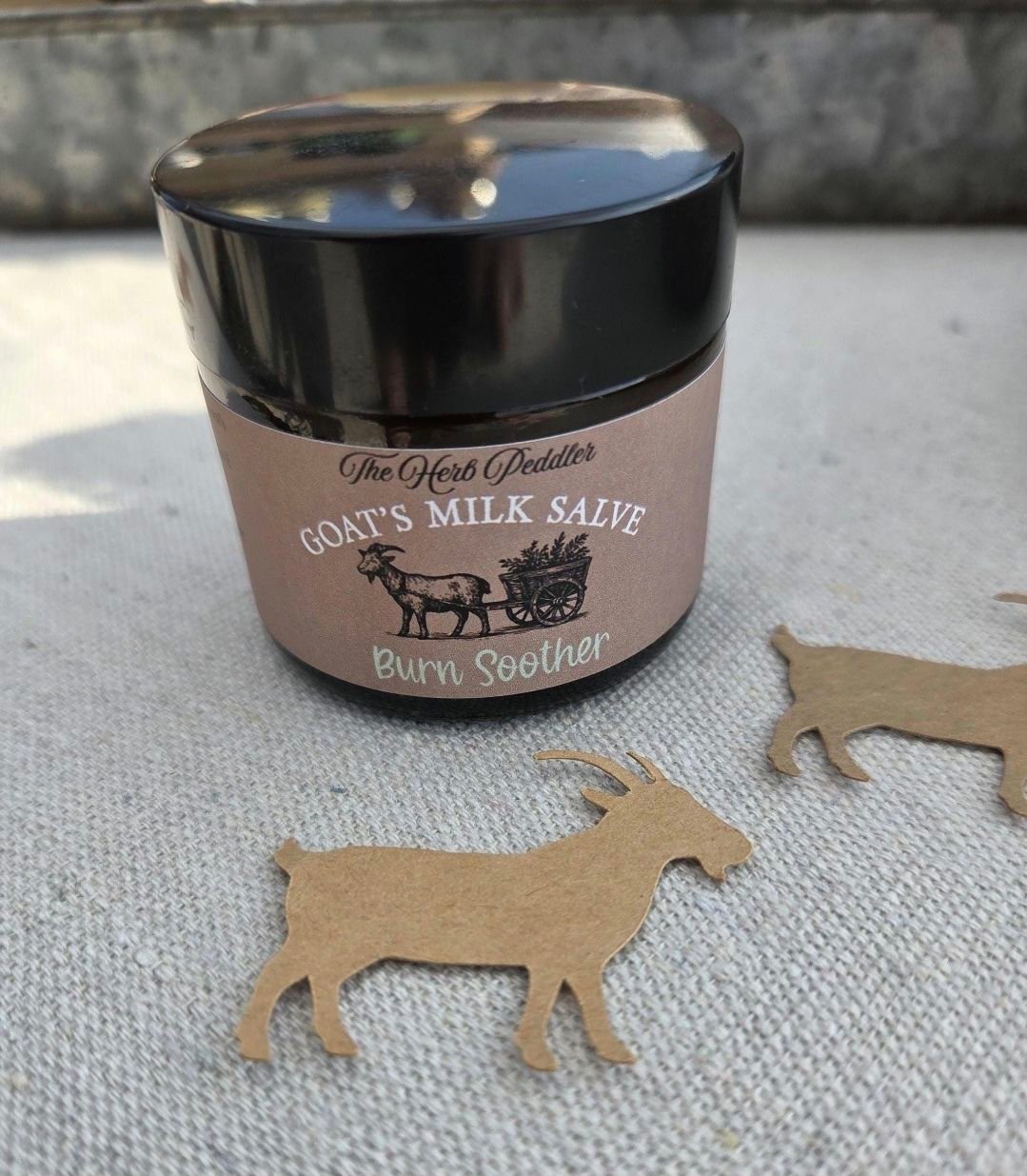 Burn Soother Goat's Milk Salve in an amber jar with lavender and chamomile flowers infused - The Herb Peddler