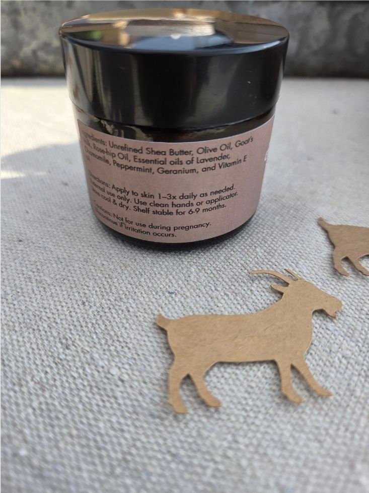 Burn Soother Goat's Milk Salve in an amber jar with lavender and chamomile flowers infused - back of jar - The Herb Peddler